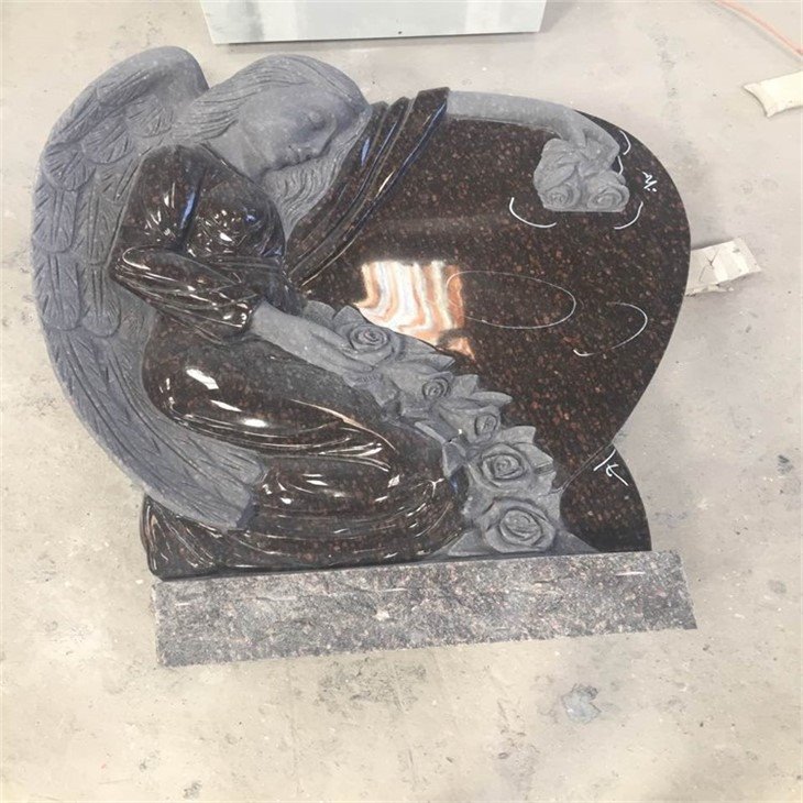 Angel holding heart monument